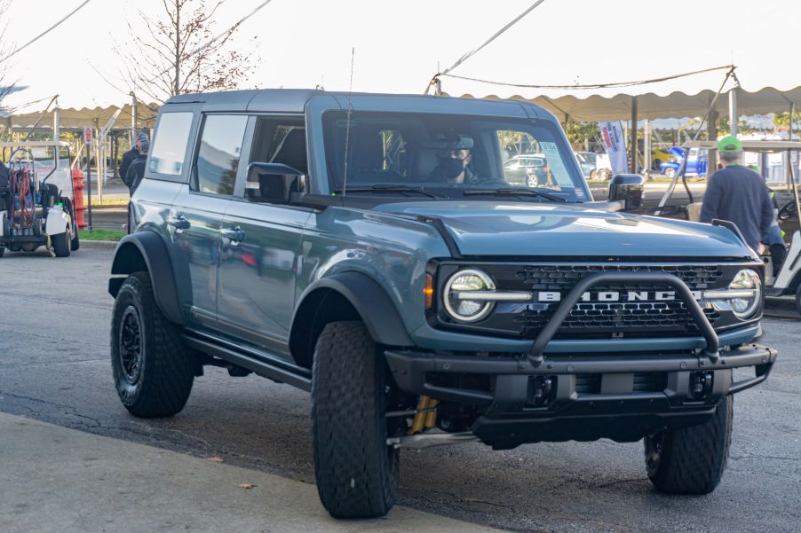 A blue 2021 Ford Bronco First Edition 4-Door entering the floor of the 2021 Mecum Chicago auction
