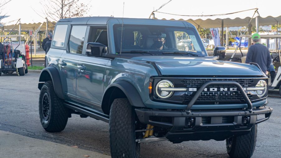 A blue 2021 Ford Bronco First Edition 4-Door entering the floor of the 2021 Mecum Chicago auction