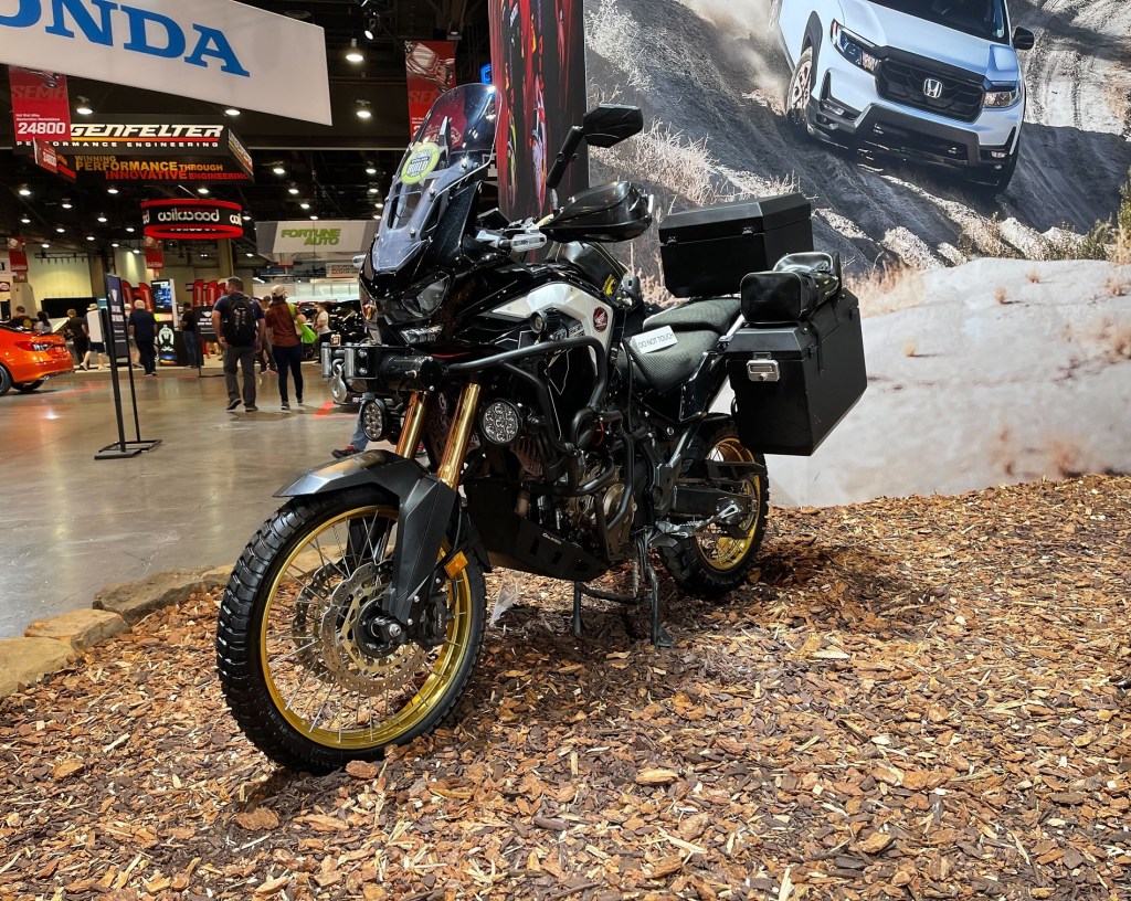 The front 3/4 view of the black-gold-and-white 2021 Honda Africa Twin Adventure Sports Overland Expo at SEMA 2021