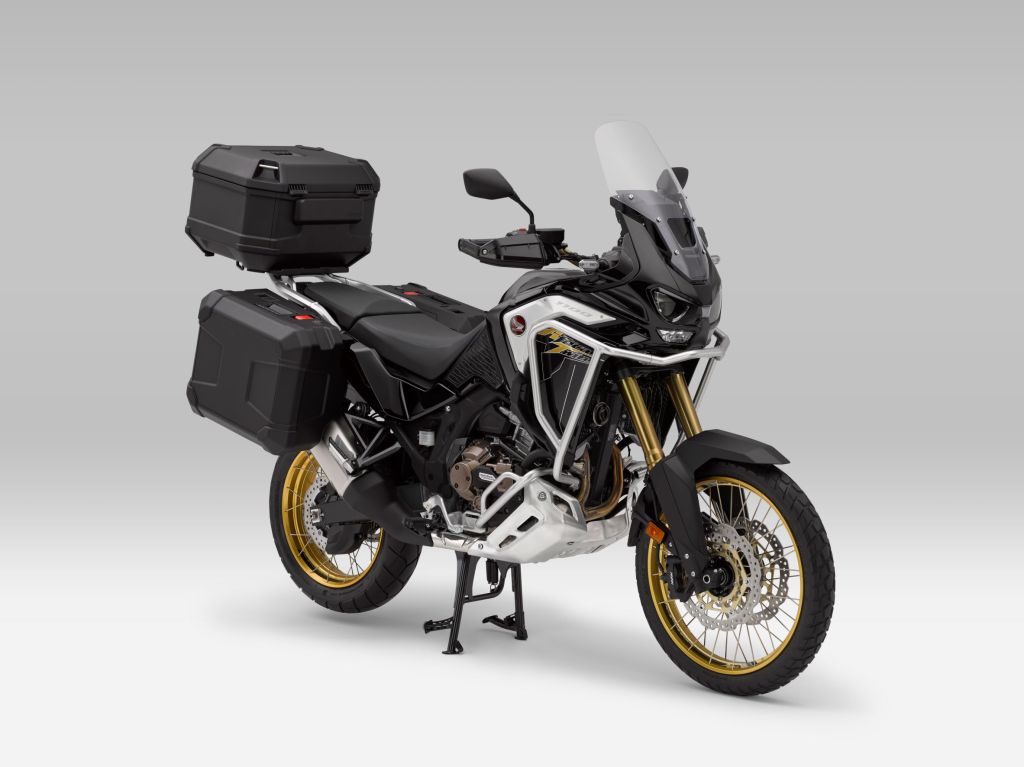A black-gold-and-silver 2021 Honda CRF1100L Africa Twin Adventure Sports ES DCT with optional accessories on its center stand