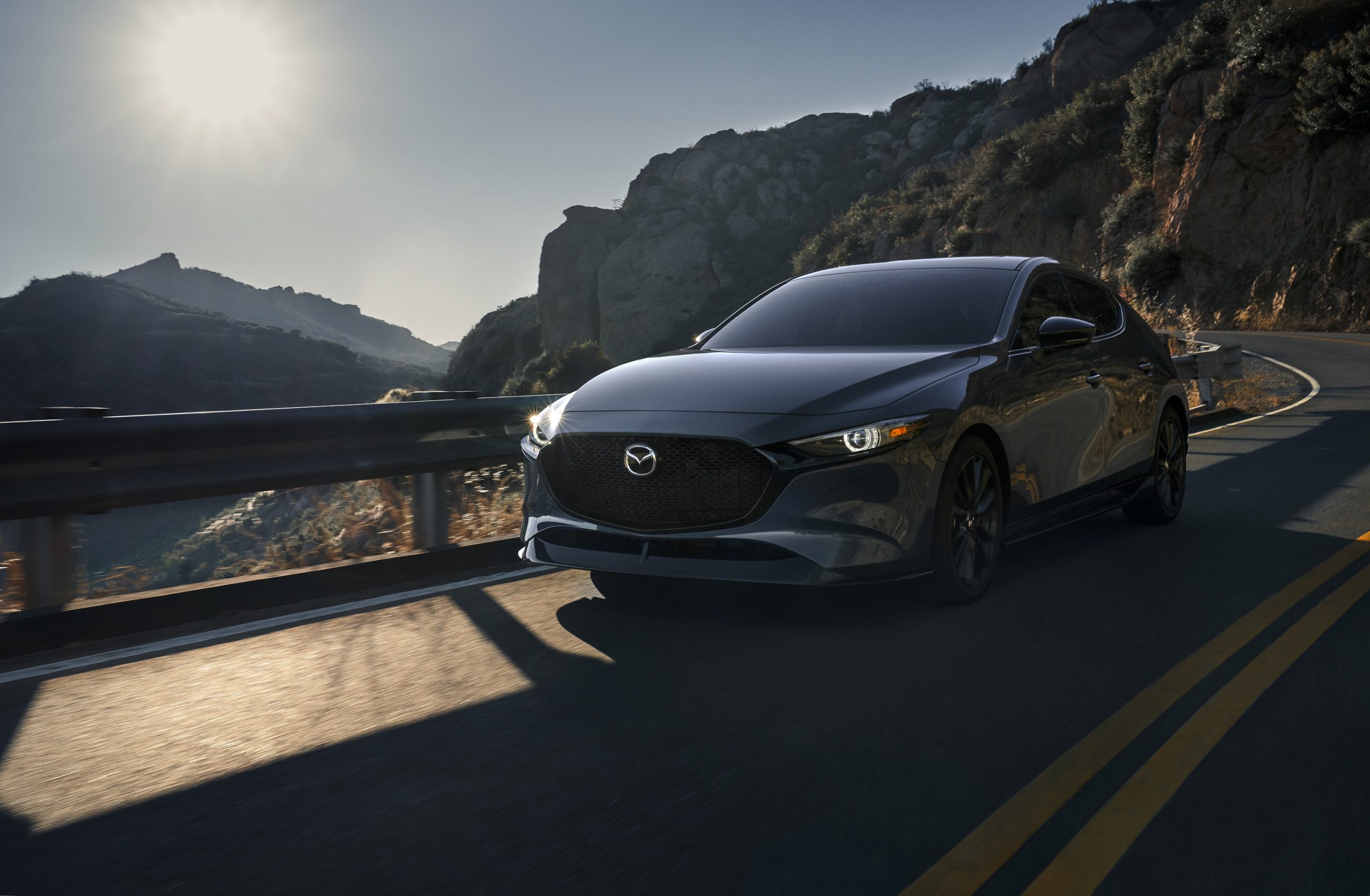  grey 2021 Mazda 3 hatchback shot in the canyons outside LA from the front 3/4