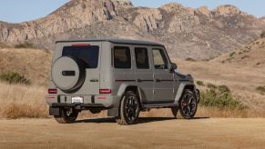 The 2021 Mercedes-Benz AMG G-Class G 63 luxury full-size SUV with a tan beige paint color option parked in the desert