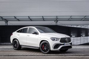 The 2021 Mercedes-Benz AMG GLE 63 S luxury coupe SUV with a white paint color option parked on a cobblestone walkway