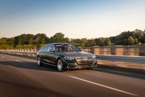 The 2021 Mercedes-Maybach S-Class luxury sedan driving down a highway next to the guard rail
