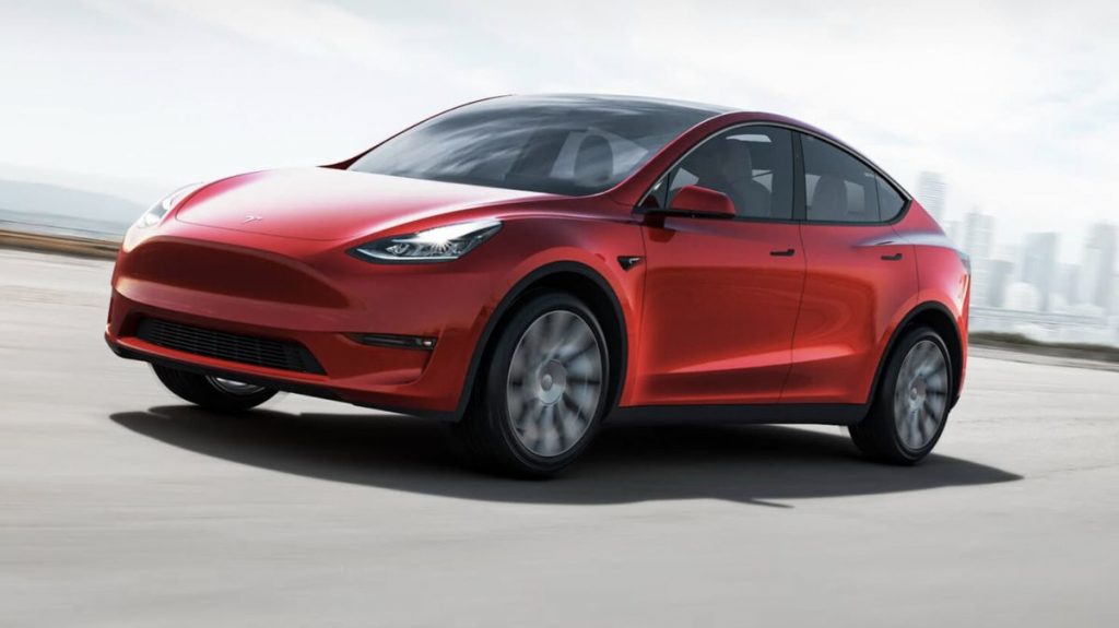 A red 2021 Tesla Model Y on the road.