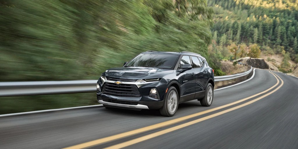 A black 2022 Chevy Blazer driving on a road with a foresty background, what's new for 2022?