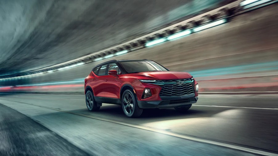 A red 2022 Chevy Blazer drives through a tunnel at night