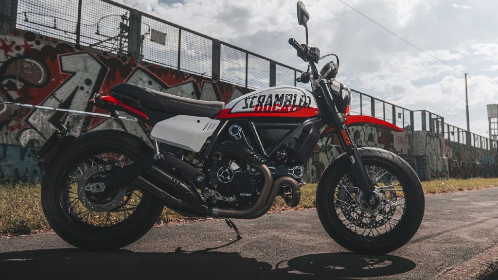 The Ducati Scrambler will be more retro and supermoto in 2022 - MotorBiscuit 5 The side view of the white and red 2022 Ducati Scrambler Urban Motard on a city street