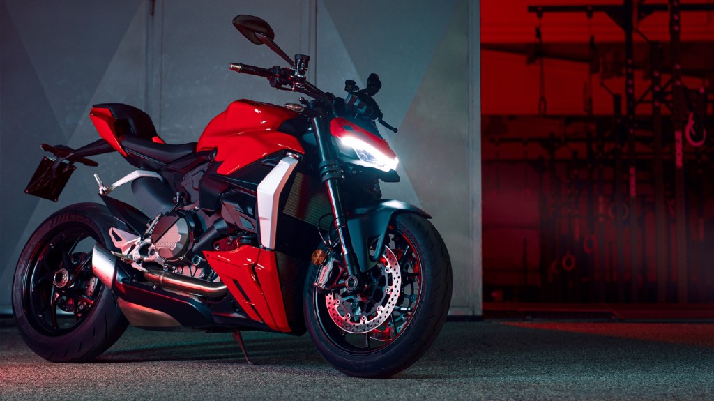 A red 2022 Ducati Streetfighter V2 parked next to a garage