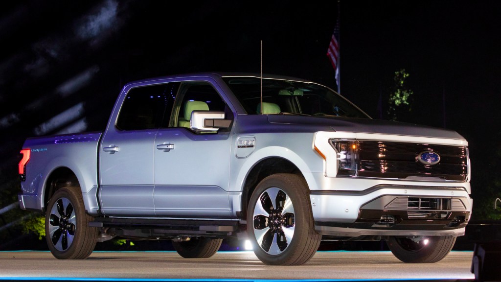 A silver 2022 Ford F-150 Lightning pickup truck is on display.