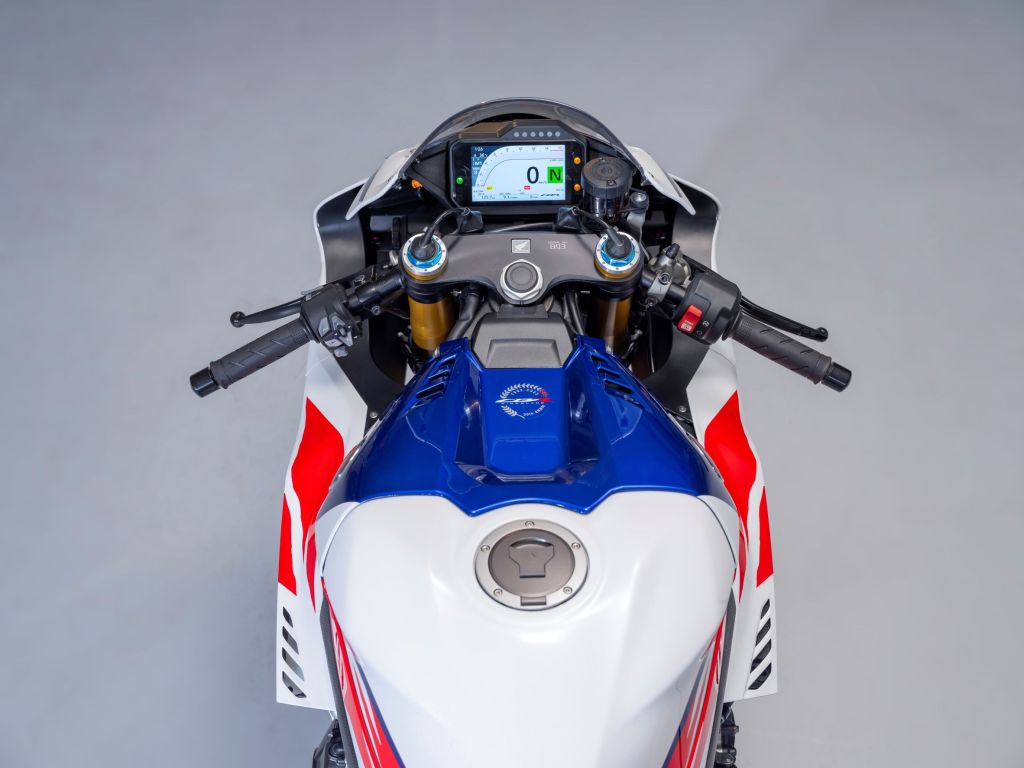 An overhead view of a white-blue-and-red 2022 Honda CBR1000RR-R Fireblade SP 30th Anniversary Edition's handlebars and TFT
