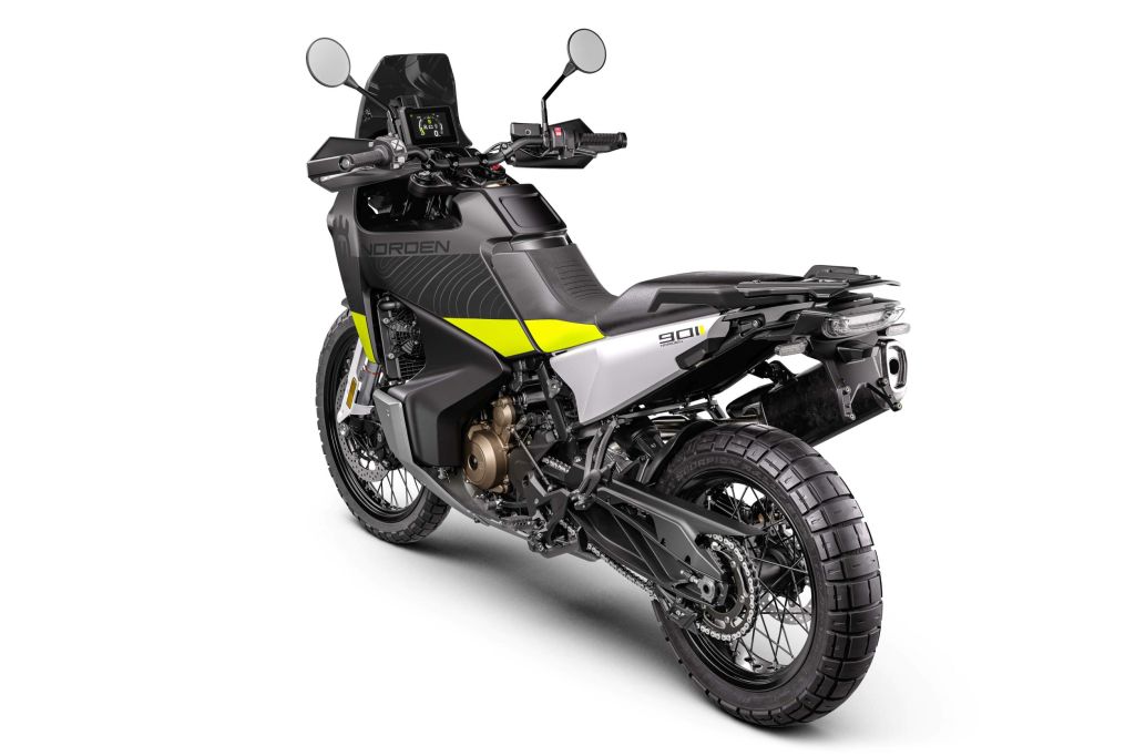 The rear 3/4 view of a black-silver-and-green 2022 Husqvarna Norden 901