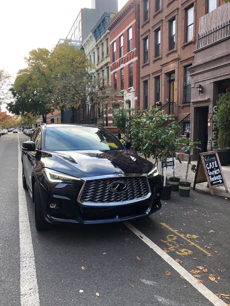 2022 Infiniti QX55 luxury review street parked in NYC. This Luxury SUV is parked in front of 9Tails coffee in Harlem. 