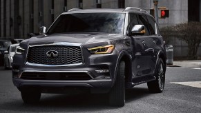 A Gray 2022 Infiniti QX80 turning through an intersection in the city