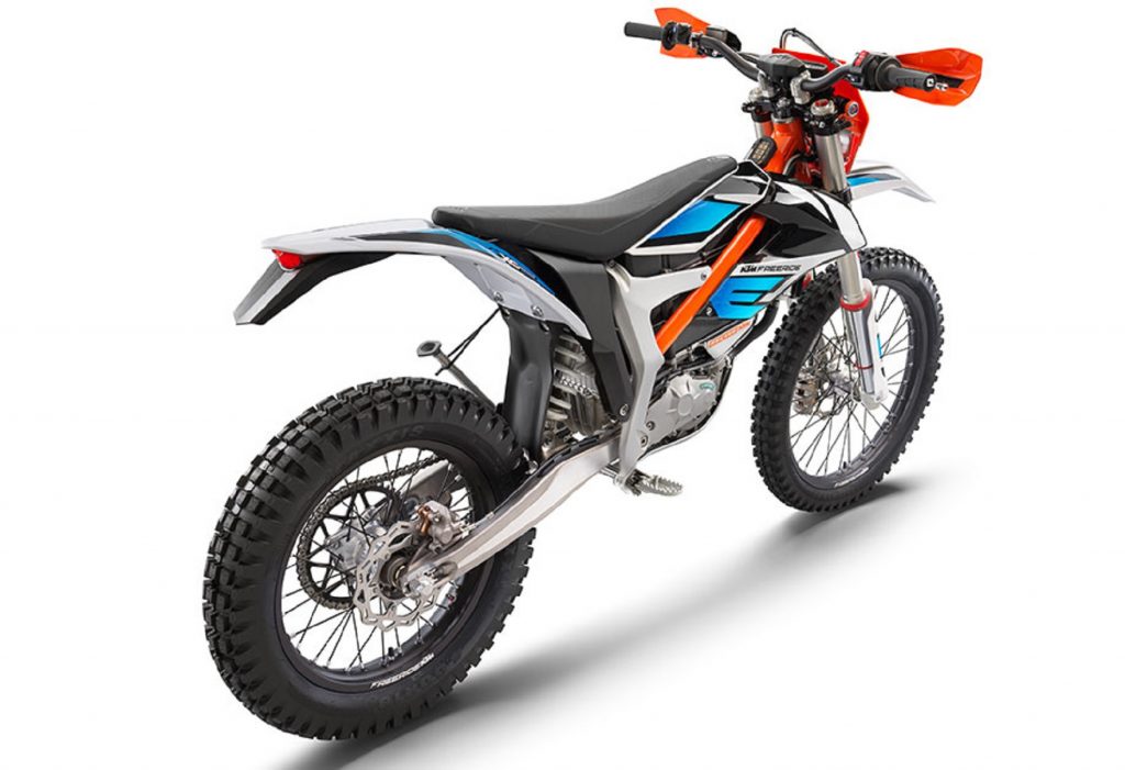 The rear 3/4 view of an orange-blue-and-black 2022 KTM Freeride E-XC electric dirt bike