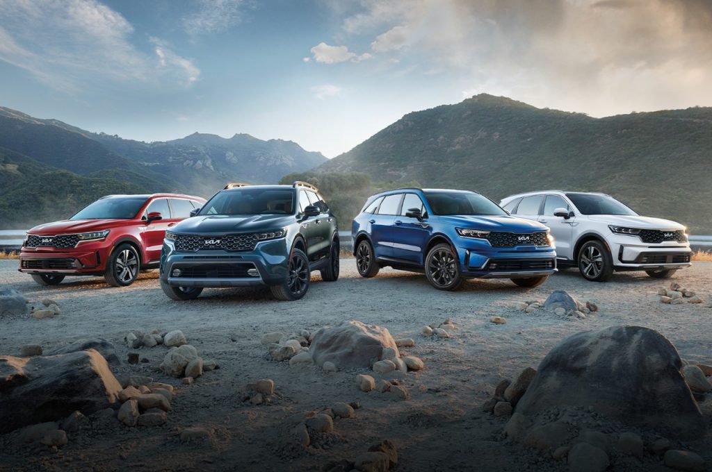 Four Kia Sportages sit on a mountain top.