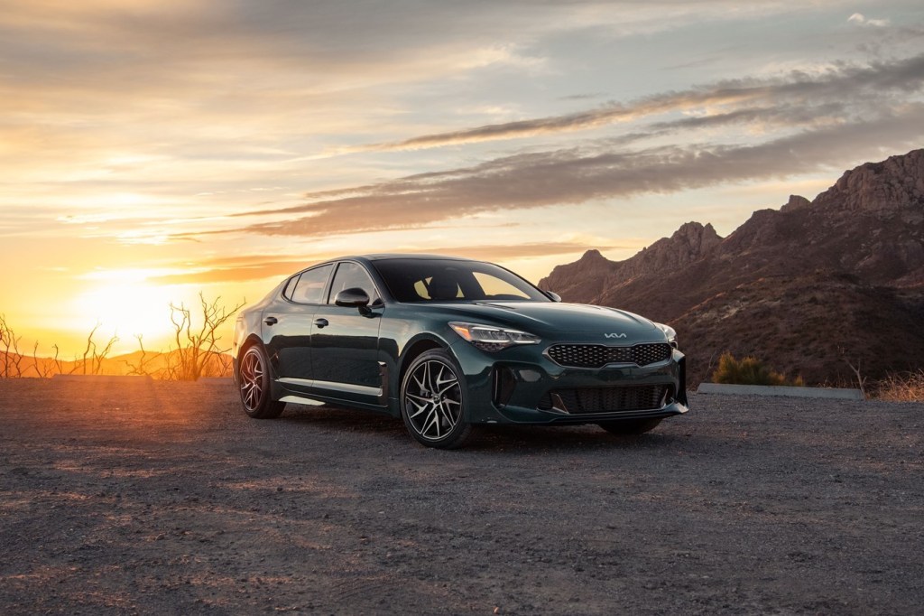 The 2022 Kia Stinger parked inthe dirt at sunset. We better enjoy the Stinger while it lasts, the EV6 GT might be killing it. 