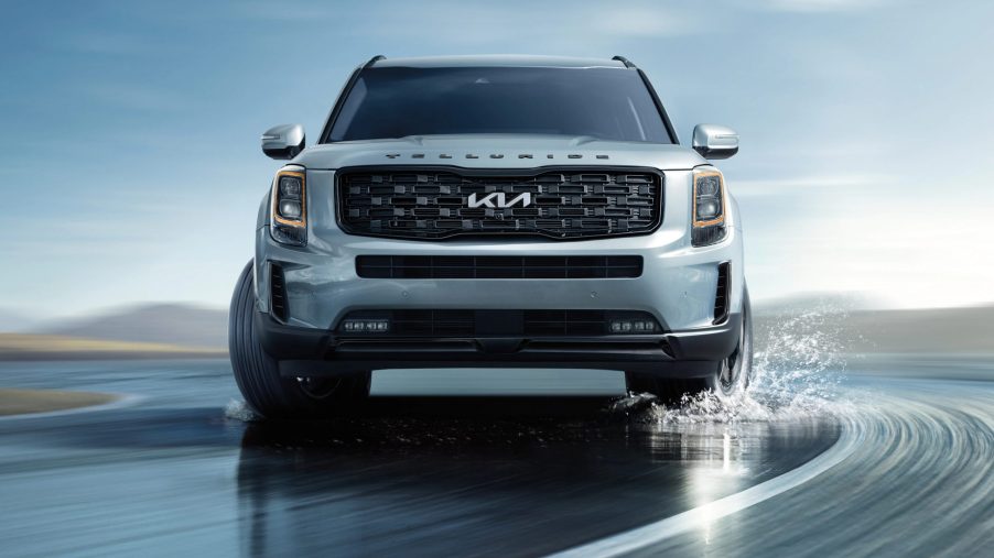 A 2022 Kia Telluride driving on the road with water on it, what's new for 2022?