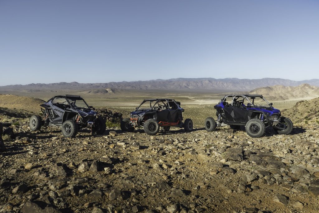 Three different 2022 Polaris RZR Pro R side-by-sides in the desert