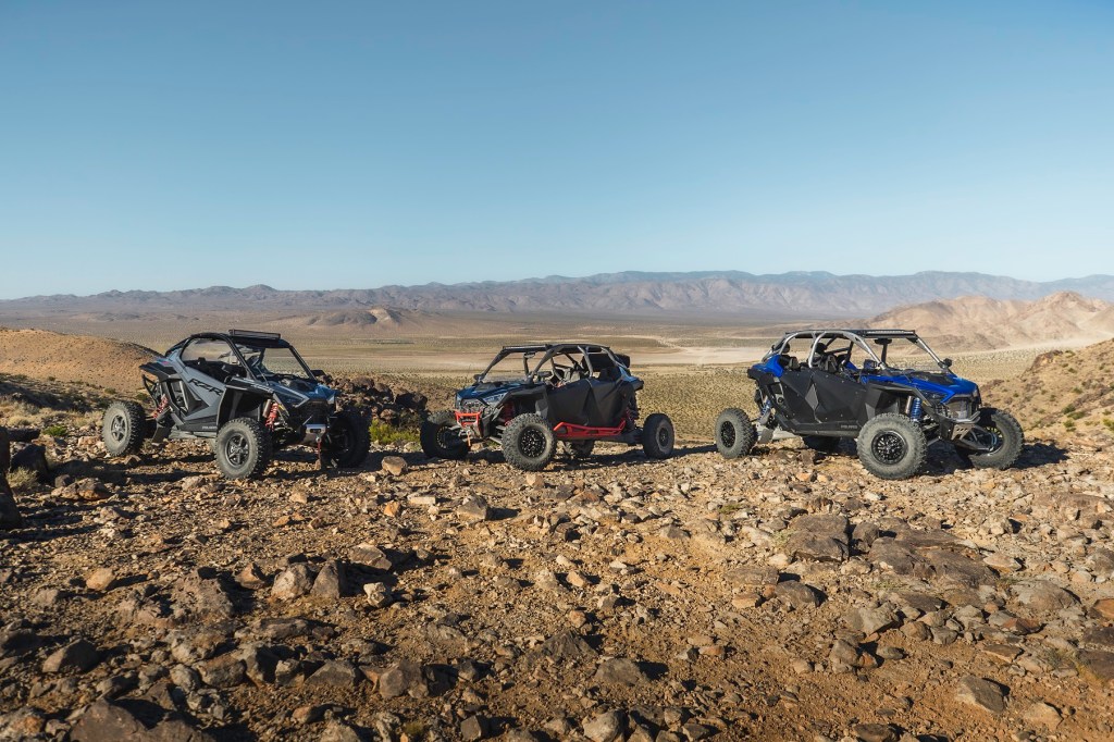 Three different 2022 Polaris RZR Pro R side-by-sides in the desert