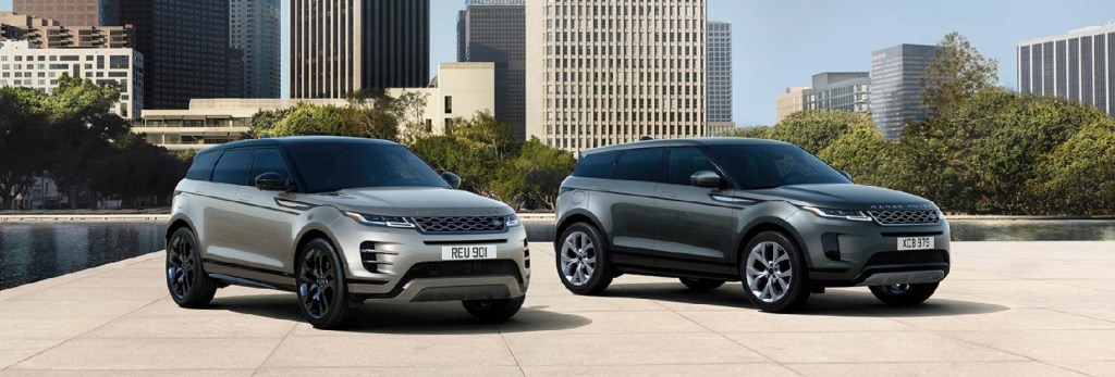A gold and a gray 2022 Land Rover Range Rover Evoques parked with a city in the background.