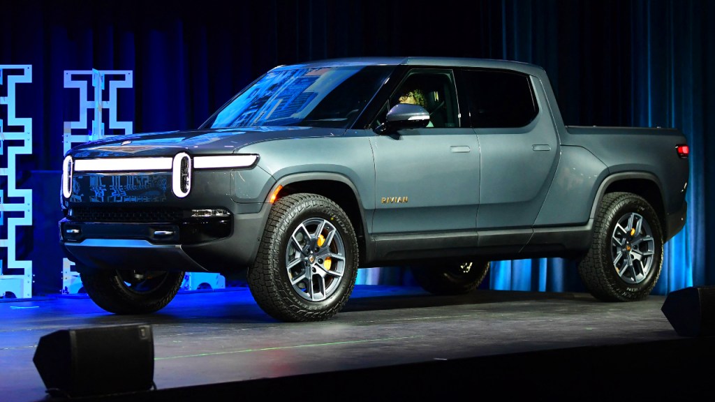 A blue 2022 Rivian R1T electric pickup truck is on display. 