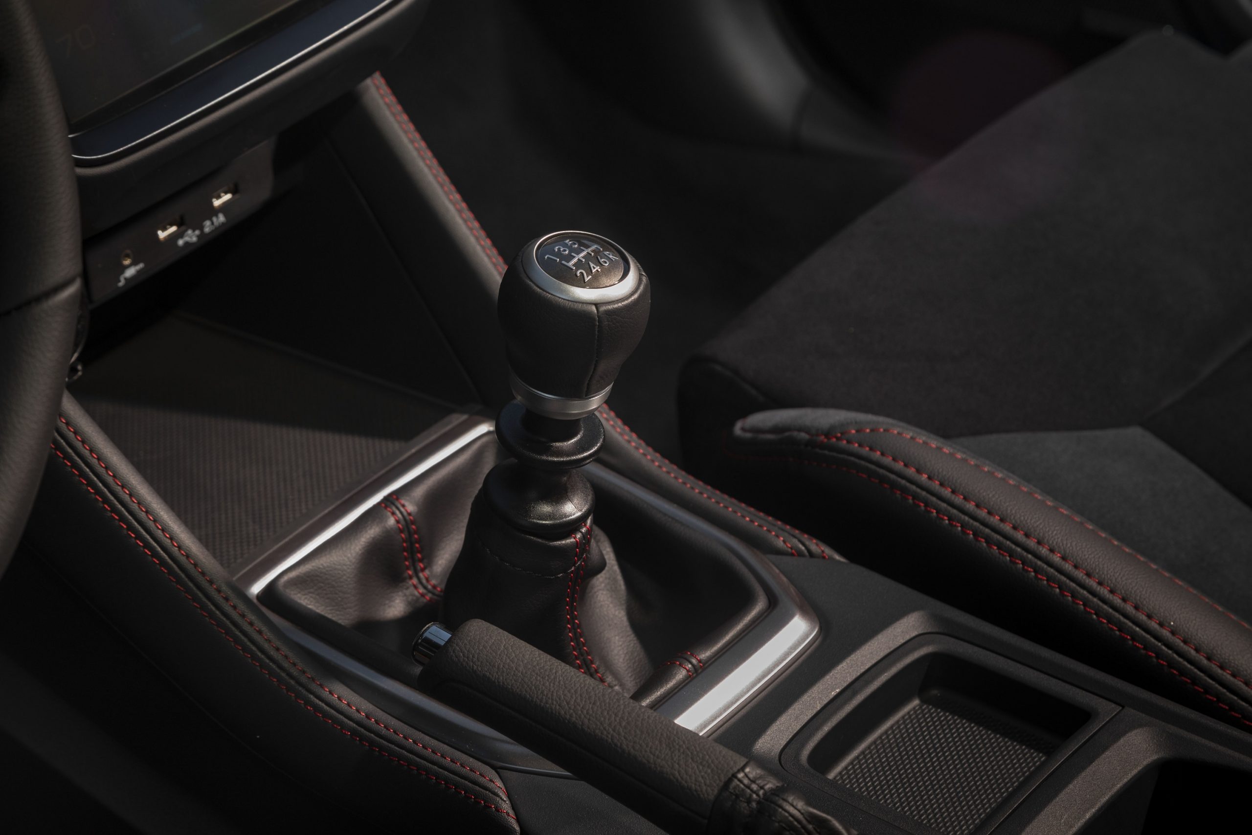 The manual transmission in the new WRX with red contrast stitching