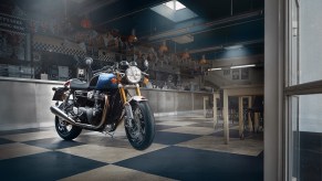A blue-white-red-and-black 2022 Triumph Thruxton RS Ton Up Special Edition in a garage