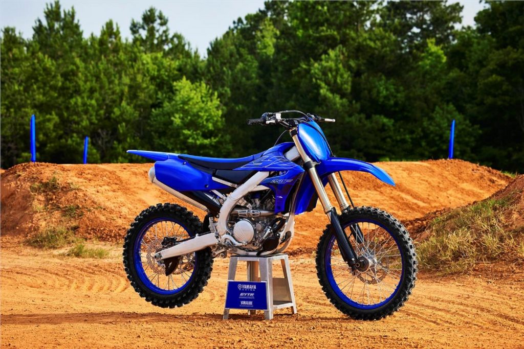 A blue-and-black 2022 Yamaha YZ250F 4-stroke dirt bike at a motocross track