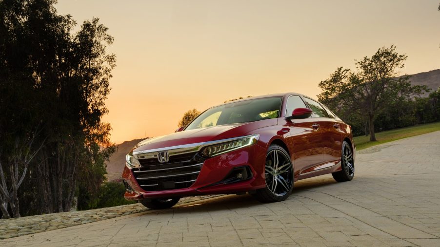 A red 2022 Honda Accord shot from the front 3/4 angle at sunset