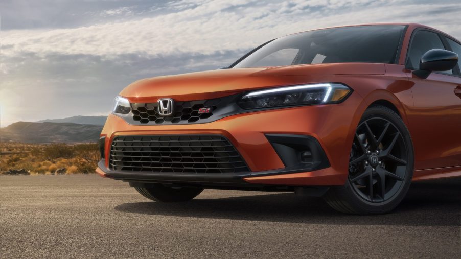 An orange VTEC-powered 2022 Honda Civic Si shot from the front