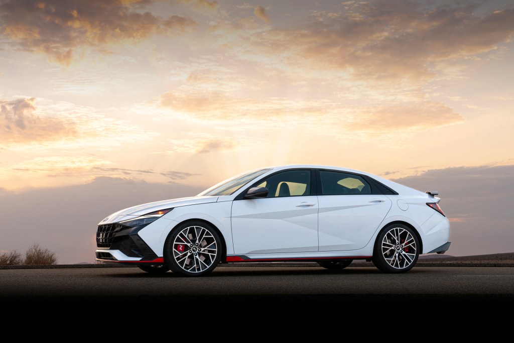 A white 2022 Hyundai Elantra N shot from the front 3/4 at sunset