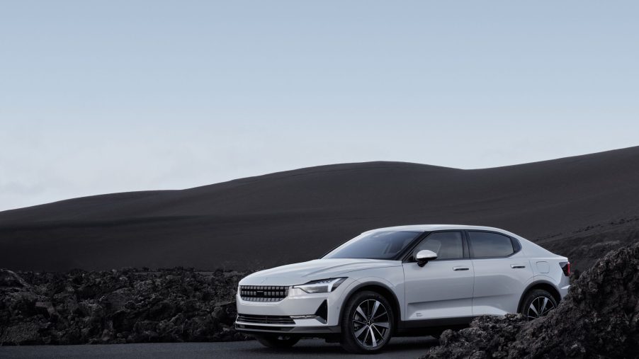 A white 2022 Polestar 2 luxury sedan shot from the front 3/4 in a volcanic boulder field