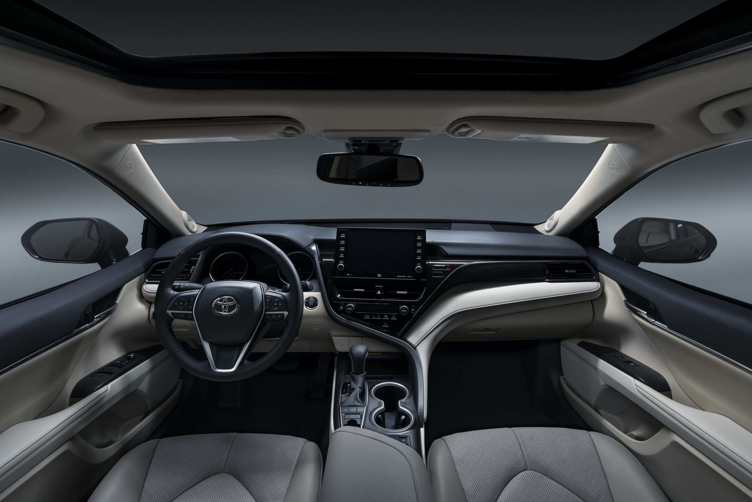 The white and black interior of the new 2022 Toyota Camry sedan
