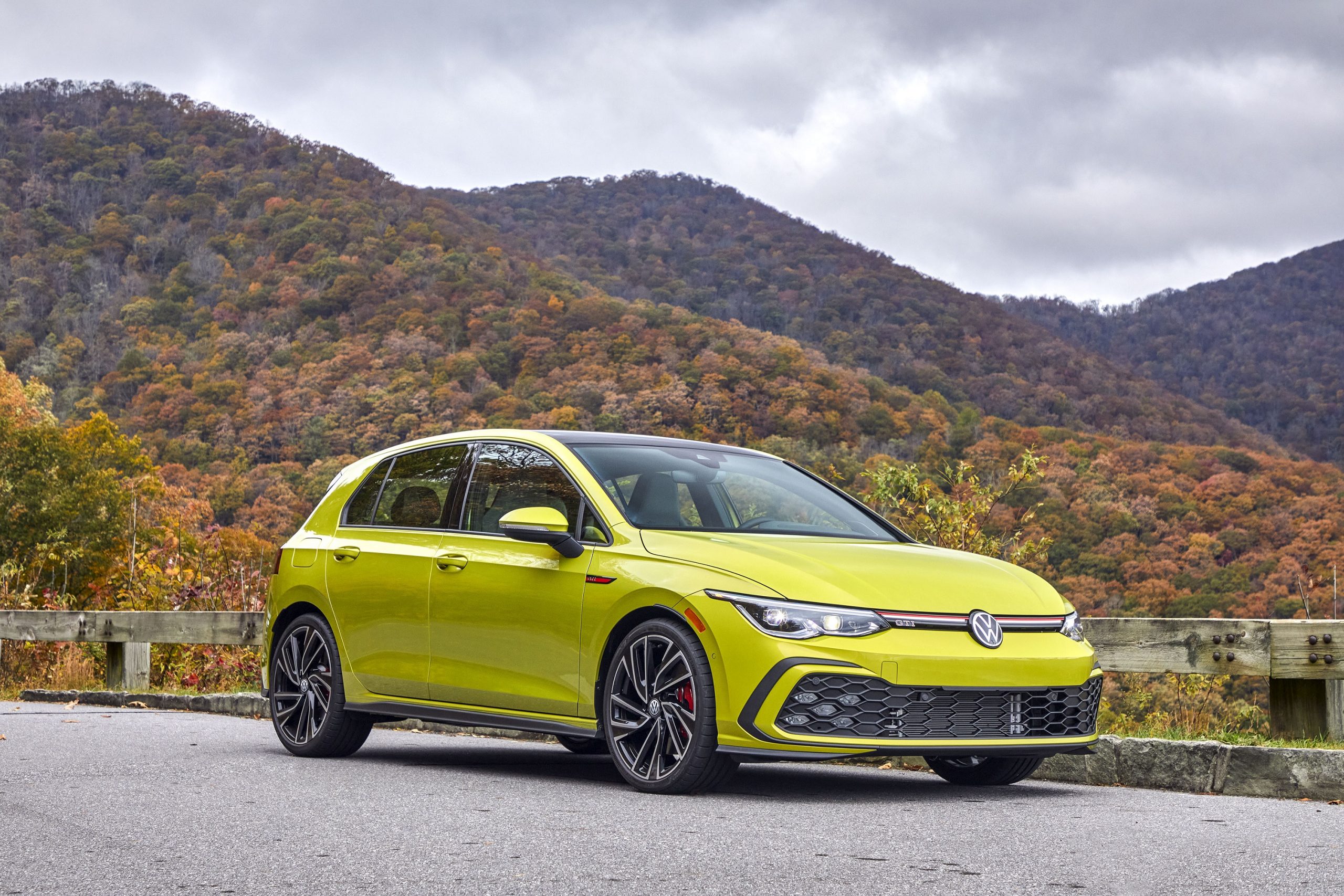 A yellow 2022 Volkswagen GTI shot from the front 3/4 on the famous Tail of the Dragon