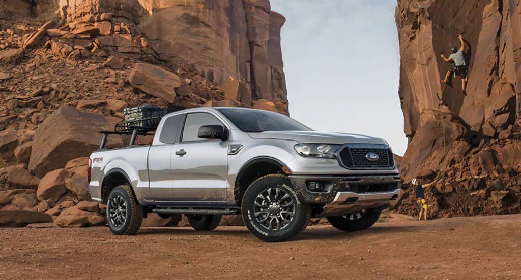 A silver Ford Ranger is parked in a mountainous region.