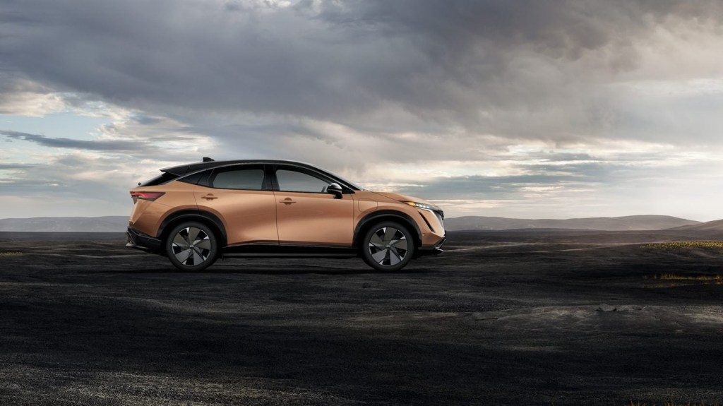 A peach 2023 Nissan Ariya parked with a dark and stormy background, how much does it cost?