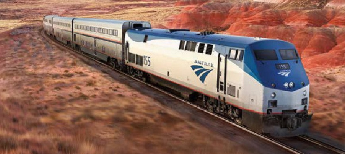 An Amtrak train racing along tracks.