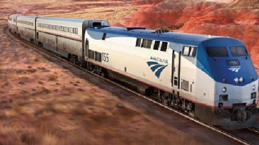 An Amtrak train racing along tracks.