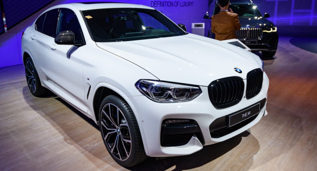 A white BMW X5 is on display.