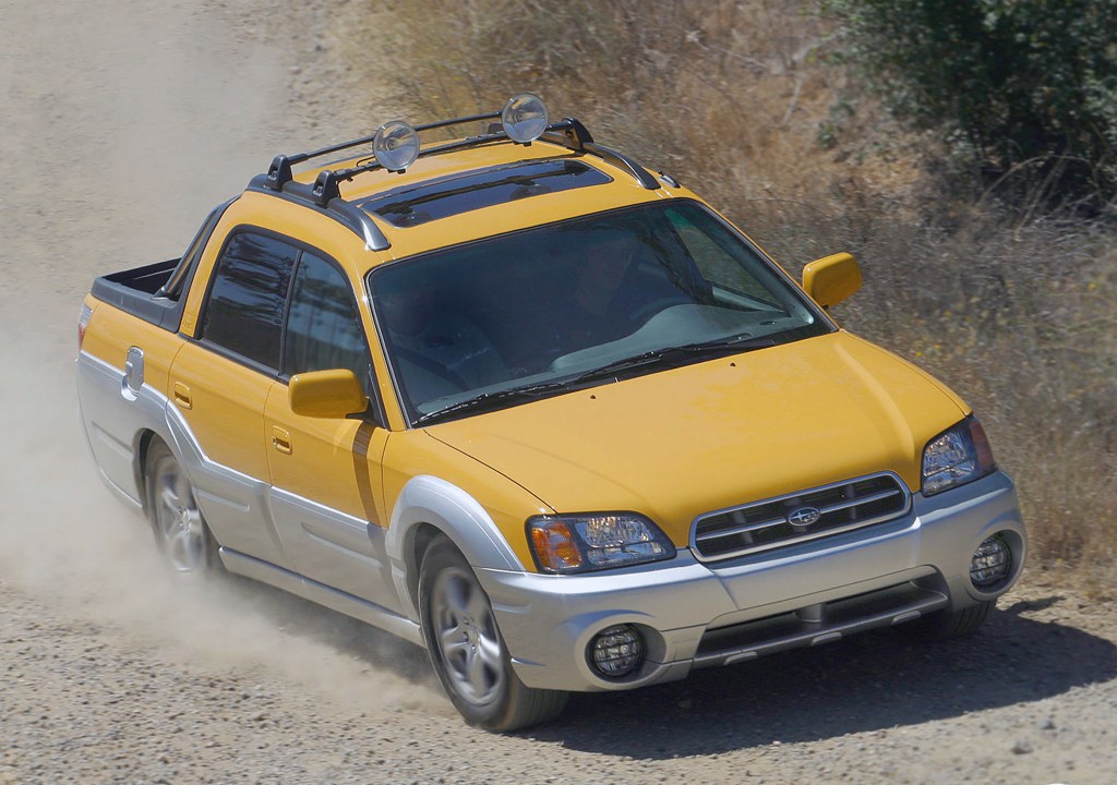Subaru Baja running down a dirt road