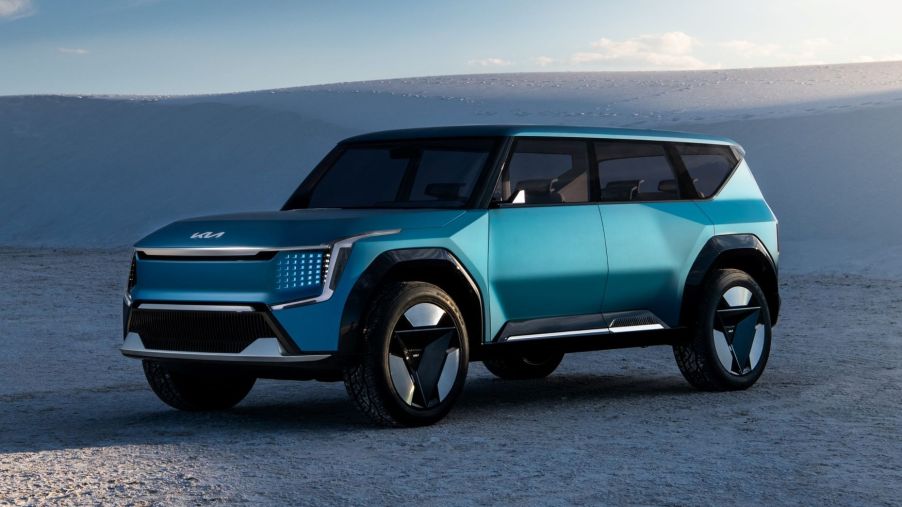 Blue-green 2024 Kia EV9 electric SUV parked in the desert