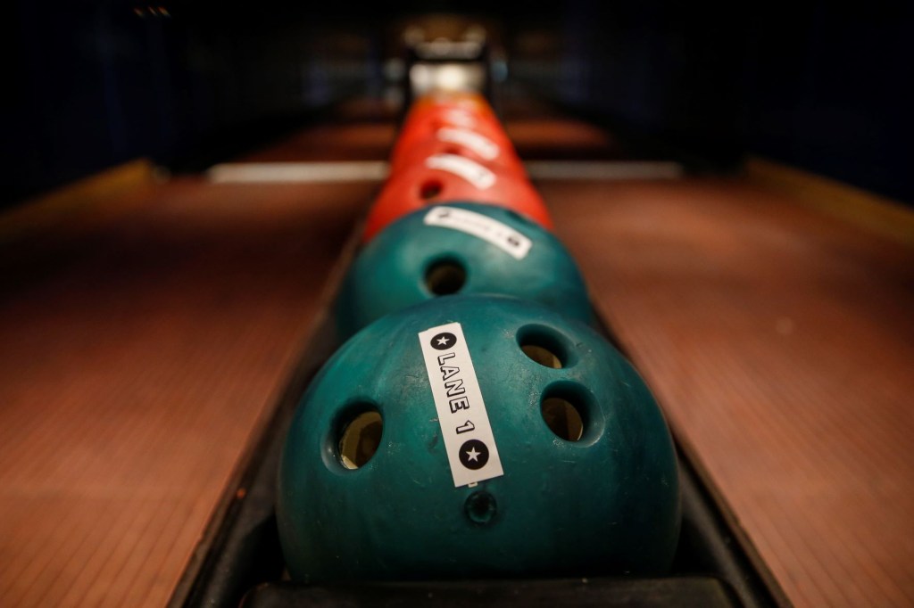 Bowling balls lined up at a bowling alley