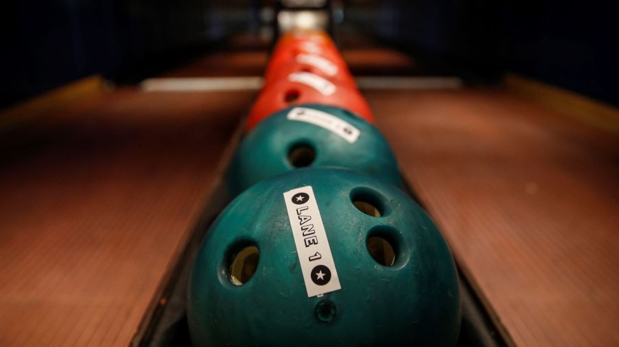 Bowling balls lined up at a bowling alley
