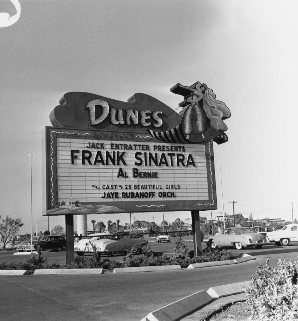 This is a photo of a Frank Sinatra sign in 1960s Las Vegas. Many road trippers sleep in a car in casino parking lots. | Archive Photos/Getty Images