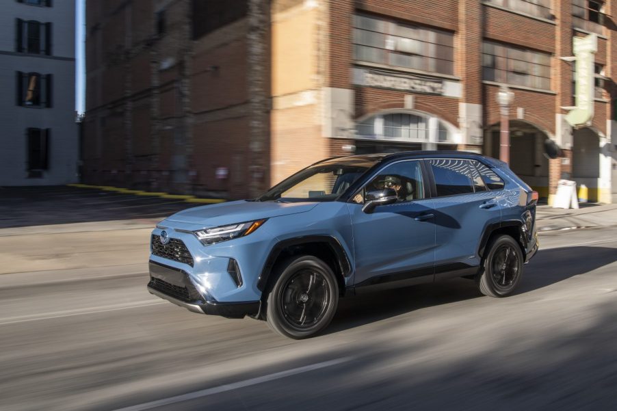 Cavalry Blue 2022 Toyota RAV4 driving down a street
