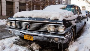 Classic car covered in snow