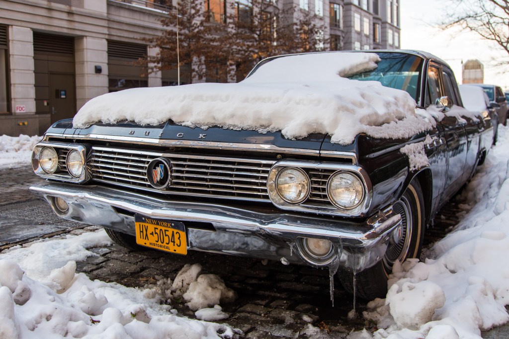 Classic car covered in snow