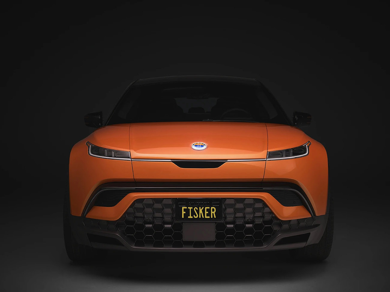 the Fisker Ocean SUV painted in orange seen from the direct front view