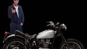 A cut out of Happy Days, The Fonz, sitting up next to Fonzie's Motorcycle, a 1949 Triumph TR5 built by Bd Ekins